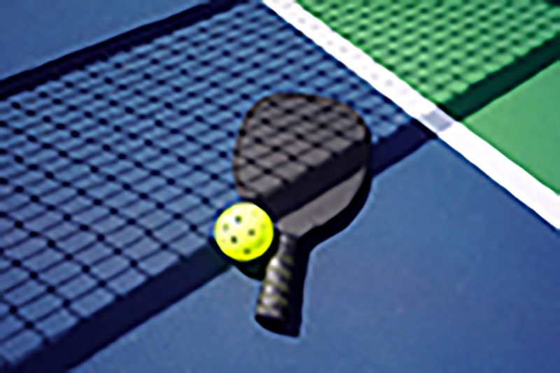 Matte Black Paddle and Ball pickleball paddle with matte black finish and a yellow ball on a court