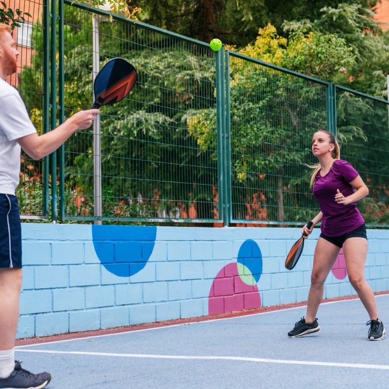 Outdoor pickleball game with players enjoying a vibrant and sunny court