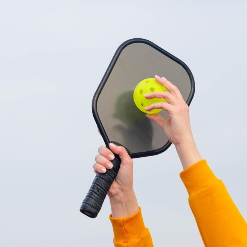 High-quality pickleball paddle on a wooden table, showcasing craftsmanship and modern design