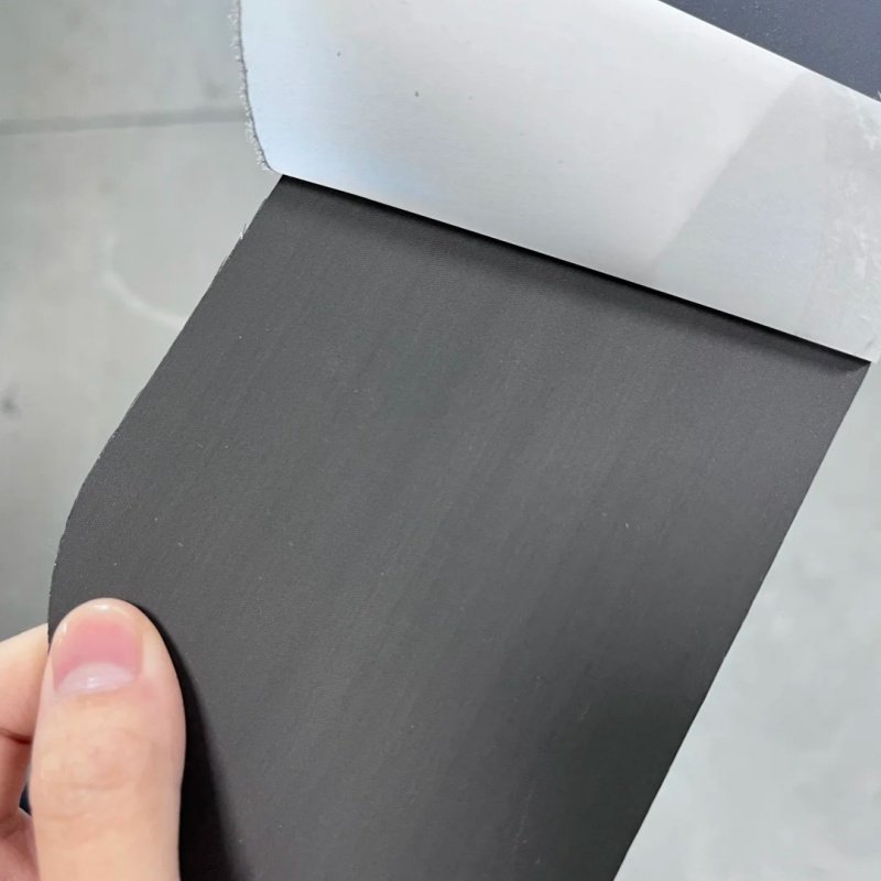 Smooth black pickleball paddle surface inspection Close-up of a smooth, black pickleball paddle surface being inspected