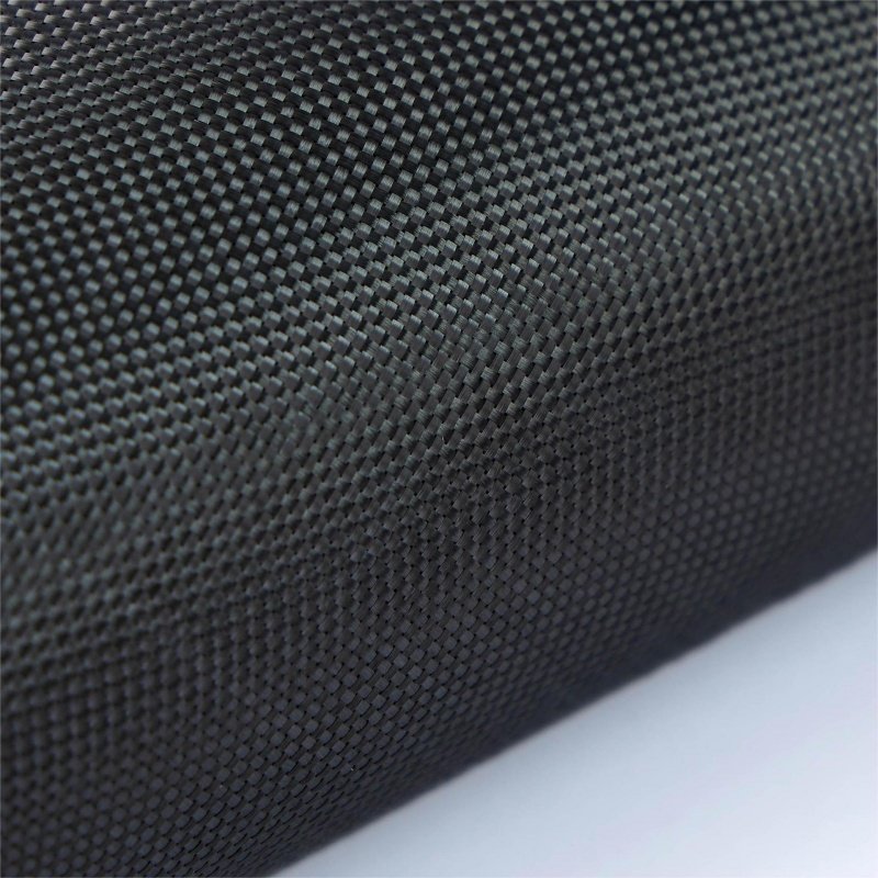 Textured carbon fiber fabric with a detailed weave pattern Close-up of carbon fiber material with woven texture