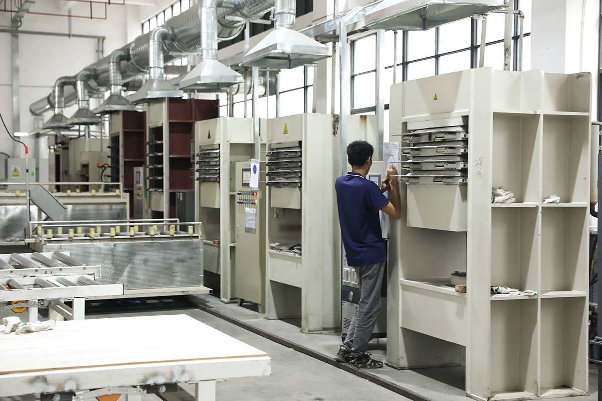Pickleball paddle production in a high-tech factory Worker operating industrial machines in a modern pickleball paddle manufacturing facility.