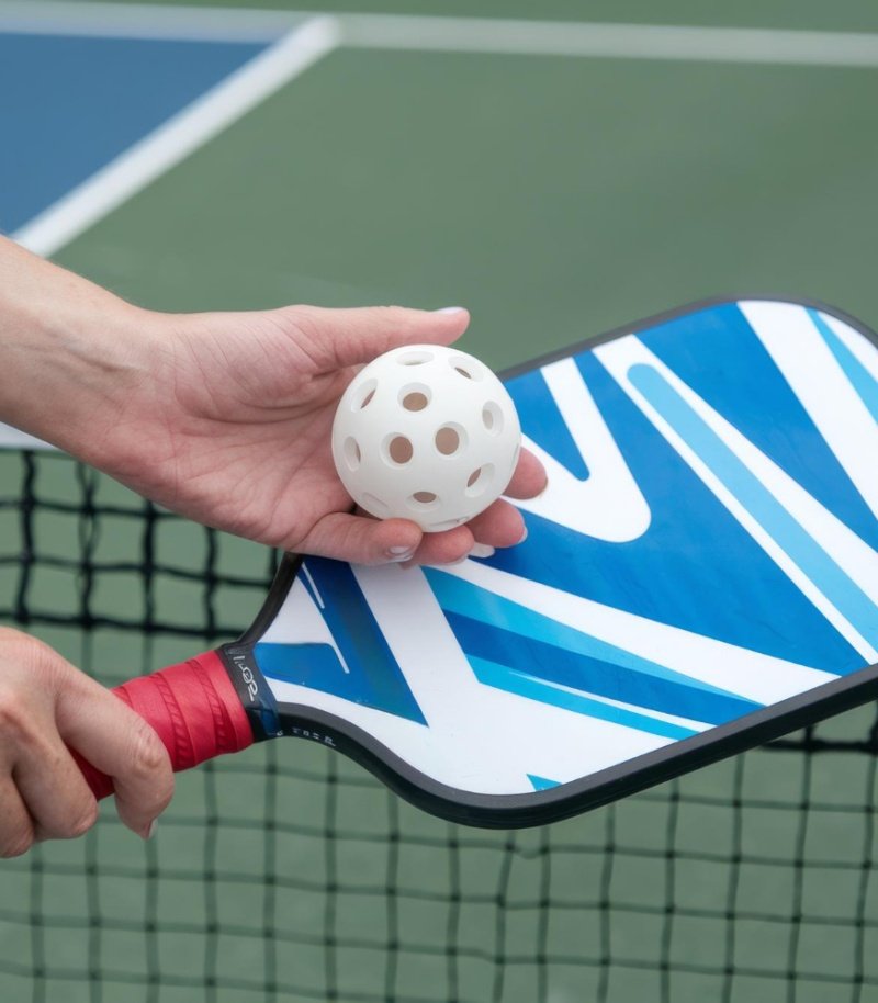 Pickleball paddle surface with a logo