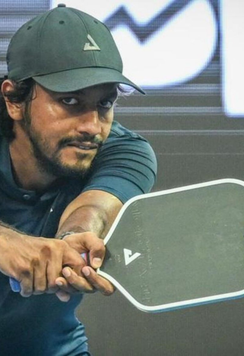 pickleball player action man focused on pickleball shot