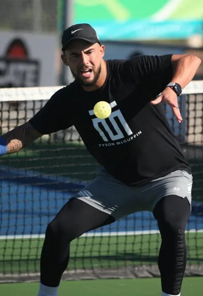 Competitive pickleball moment Pickleball player in action near the net