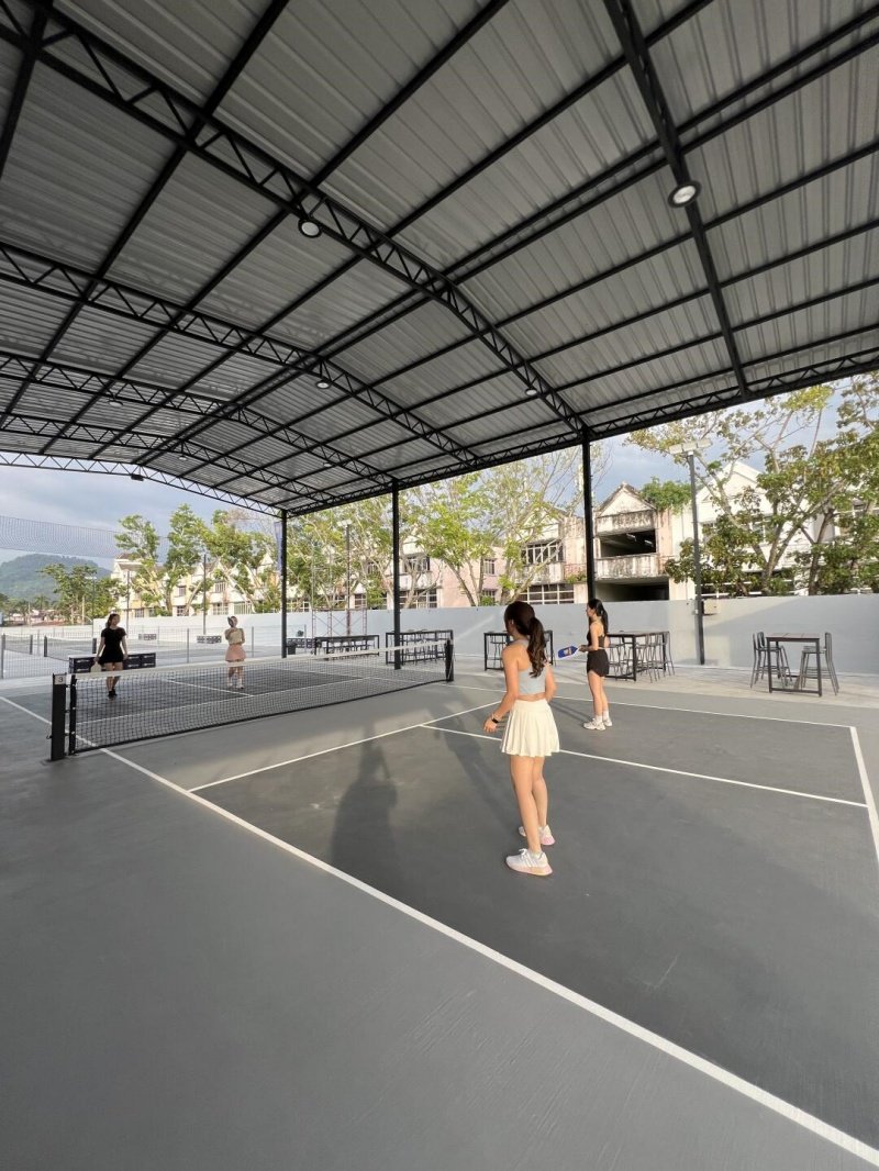 Covered Pickleball Court Game Players engaged in a pickleball match on a covered outdoor court
