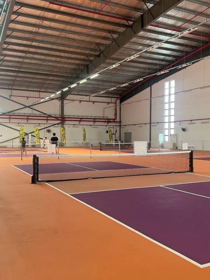 Indoor pickleball facility Indoor pickleball courts with purple and orange flooring