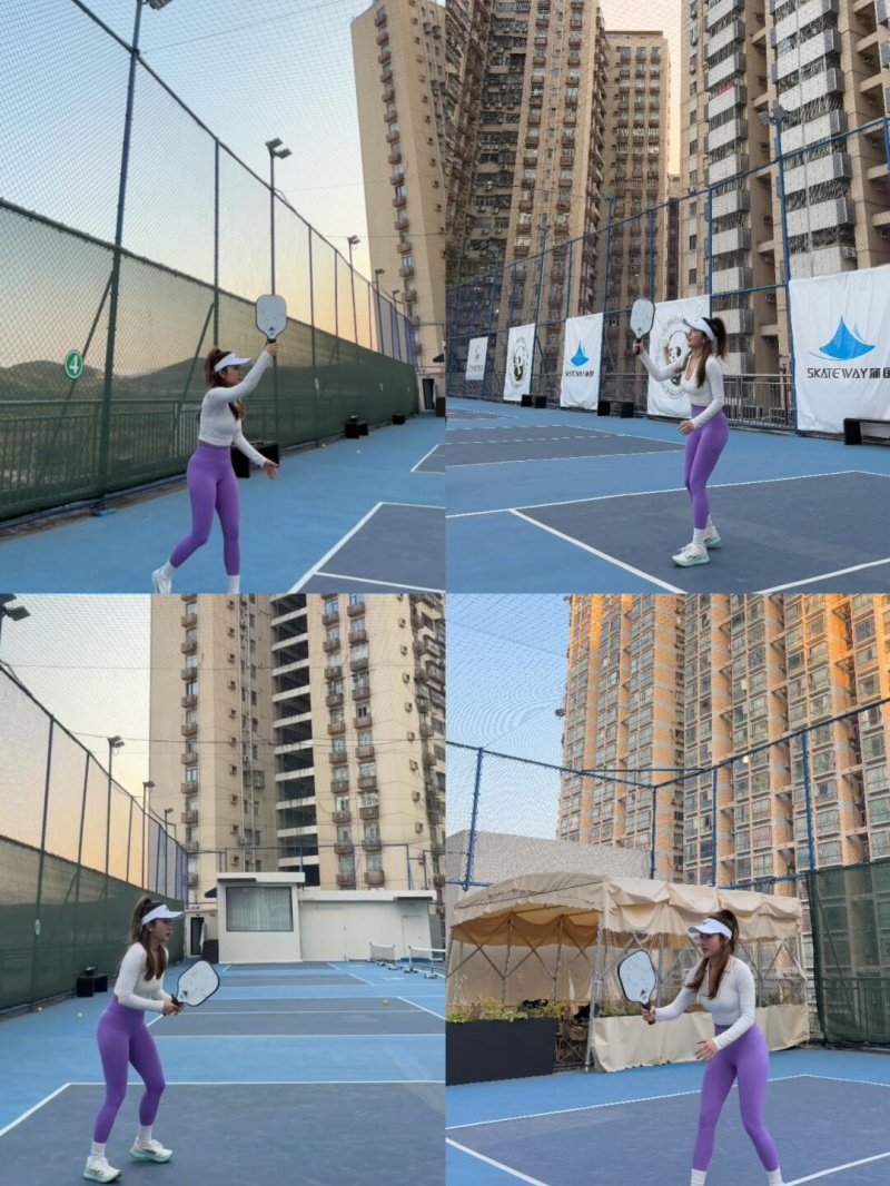 Pickleball Game in the City Woman playing pickleball on an outdoor court surrounded by tall buildings