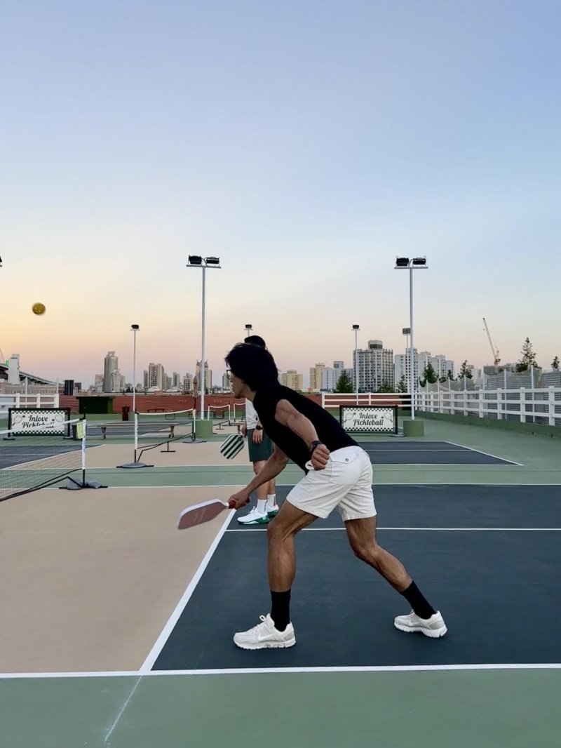 Pickleball action shot Pickleball player preparing to hit a shot on an outdoor court