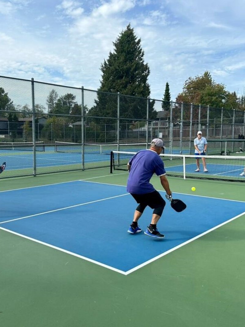 Pickleball game in action Players engaged in a pickleball match on an outdoor court