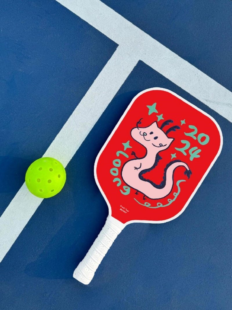 2024 Dragon Paddle Red pickleball paddle with cartoon dragon design and green ball on court