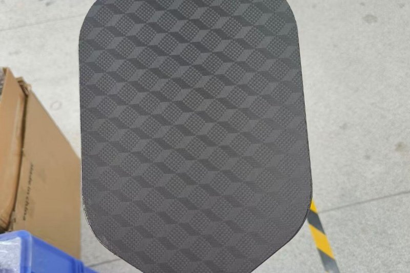 Black Geometric Paddle Surface Black carbon fiber pickleball paddle with geometric pattern