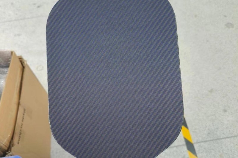 Blue carbon fiber paddle surface Close-up of a blue carbon fiber textured pickleball paddle