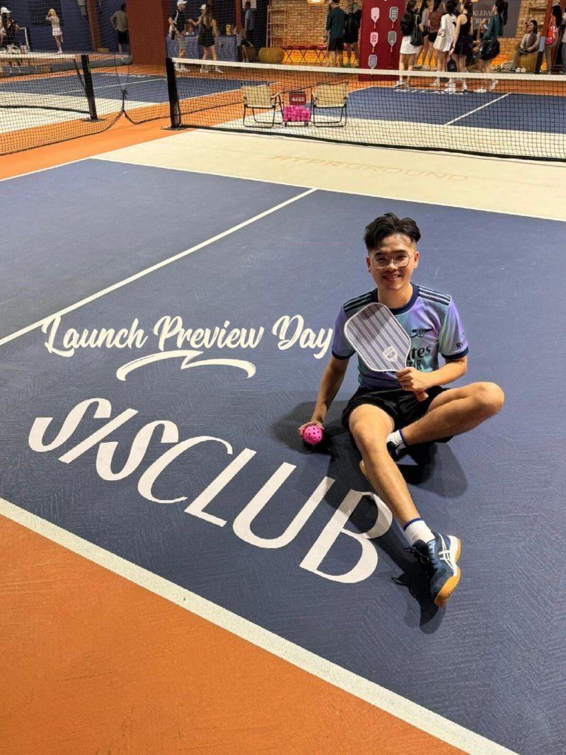 Launch Preview Day Smiling player sitting on SISClub pickleball court during launch preview