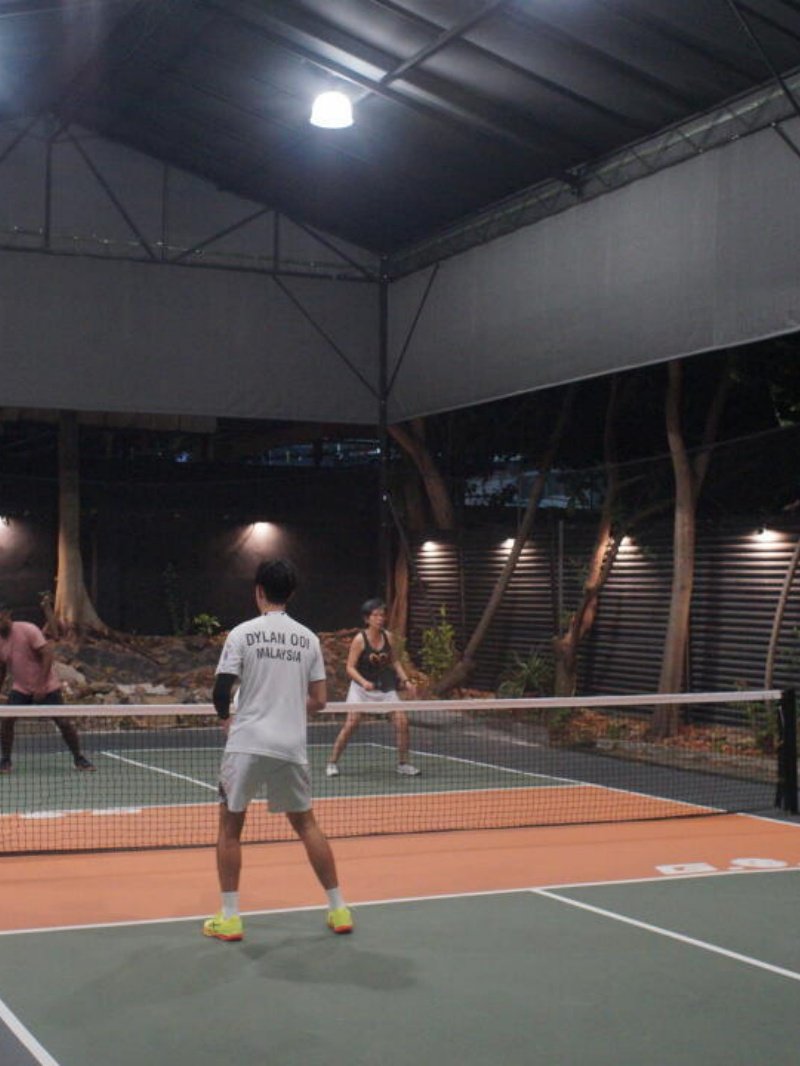Night Pickleball Game Pickleball doubles match underway on covered night court with players in action
