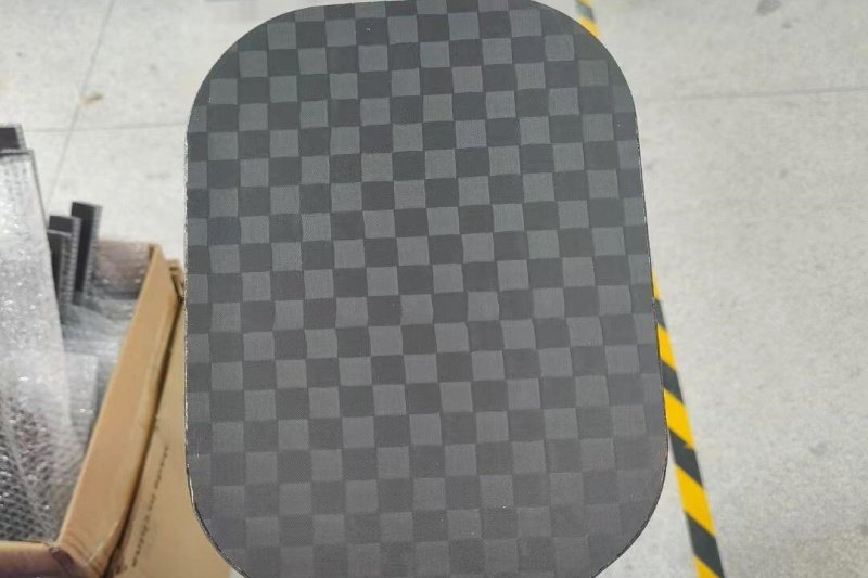 Textured pickleball paddle surface Close-up of a textured pickleball paddle surface with checkered pattern
