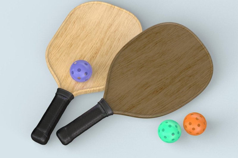 Wooden paddles with balls Two wooden pickleball paddles with colorful balls