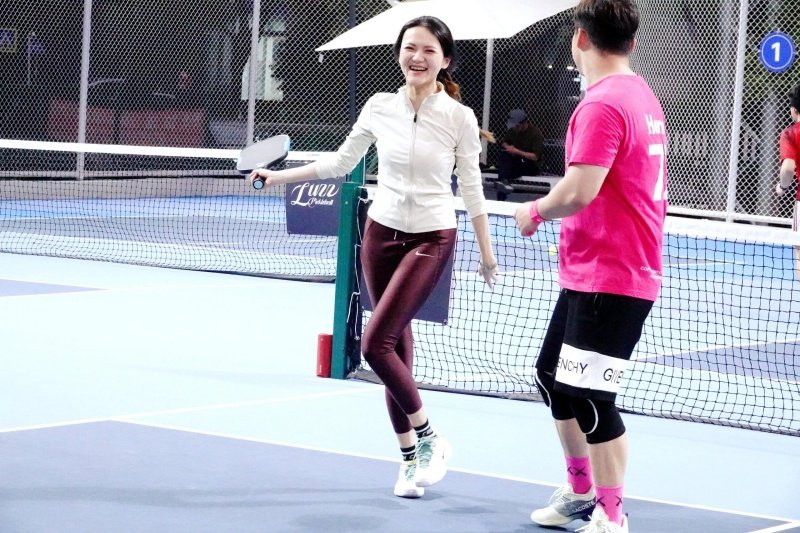 Joyful Pickleball Match Moment Smiling pickleball players on court at night