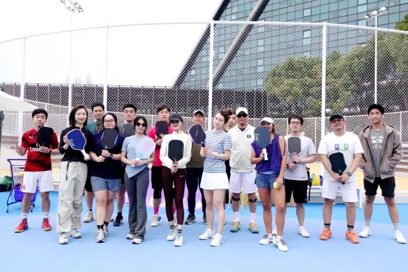 Team Photo With Paddles Group of pickleball players posing with paddles