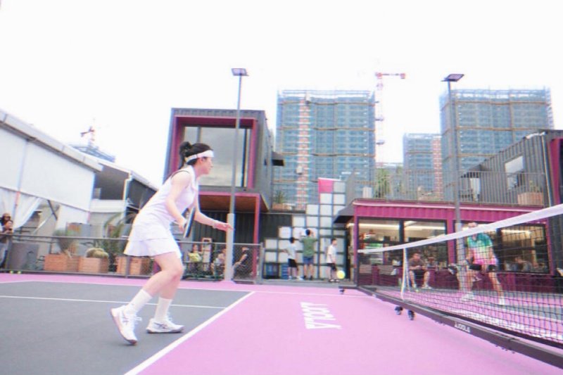 Urban Rooftop Pickleball Match Outdoor pickleball game on pink court with urban skyline