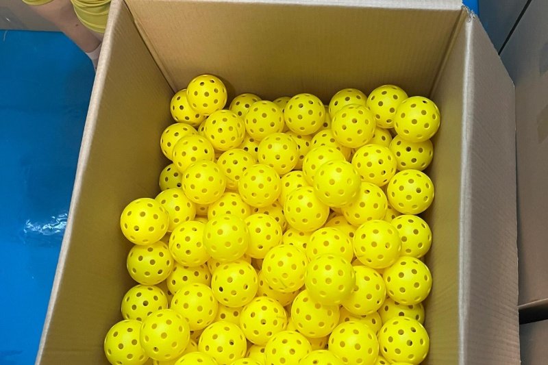 Yellow Pickleballs in Bulk Box full of bright yellow pickleballs ready for shipment